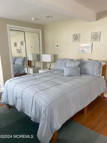 a bedroom with a bed and a night stand