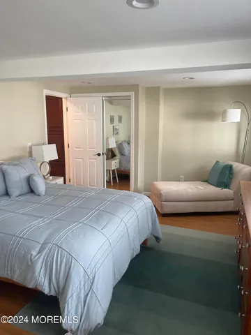 a bedroom with a bed and a night stand