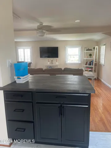 a kitchen with a wooden floor and cabinets