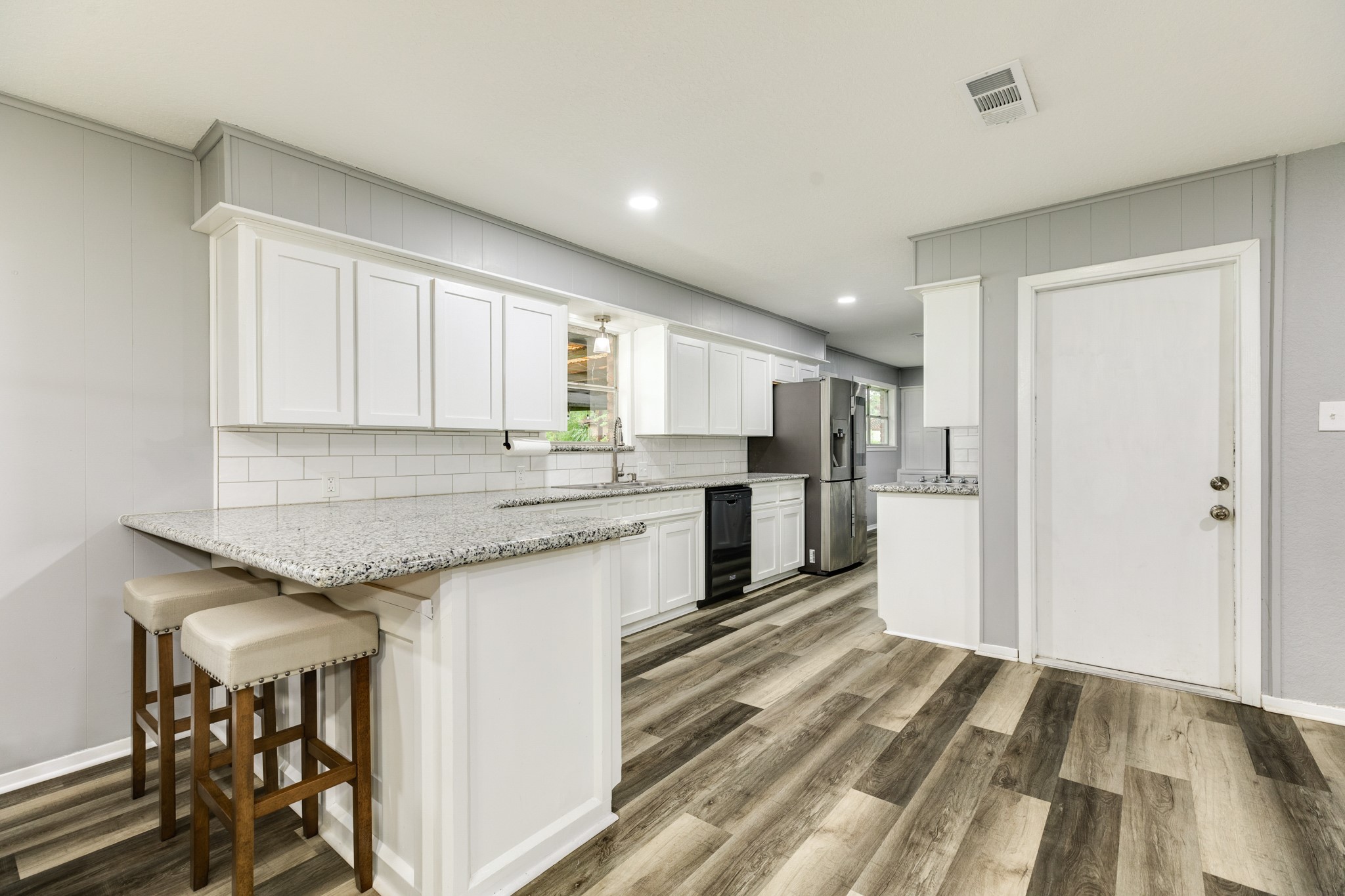 908 West Mulberry Street Angleton, TX 77515 - Photo 8 of 22 a kitchen with granite countertop cabinets stainless steel appliances and a island