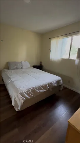 a bedroom with a bed and window