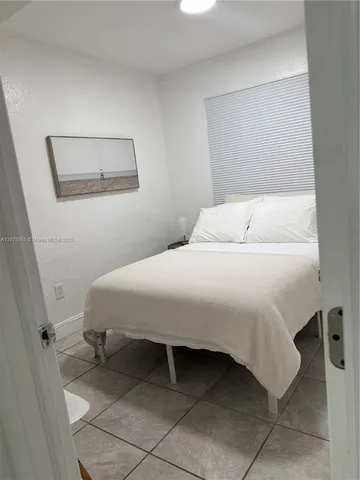 a bedroom with a bed and a mirror