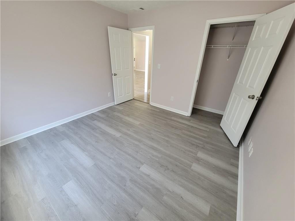 2213 Carlton Chase Road Dacula, GA 30019 - Photo 19 of 30 a view of a hallway with wooden floor