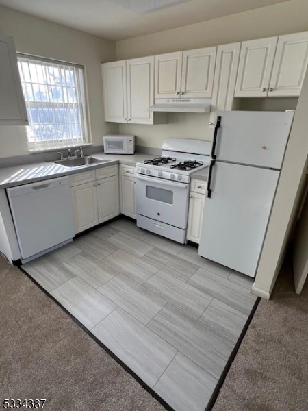 3203 Vail Road Parsippany, NJ 07054 - Photo 12 of 18 a kitchen with white cabinets a sink a window and white appliances
