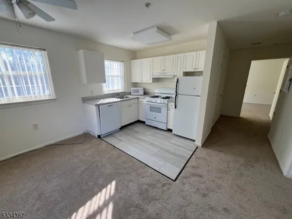 a kitchen with cabinets a sink and a window