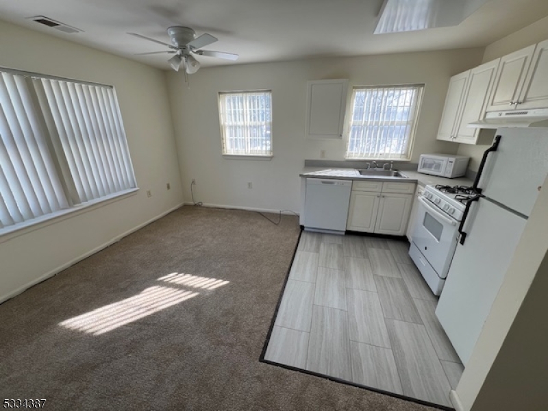3203 Vail Road Parsippany, NJ 07054 - Photo 15 of 18 a kitchen with cabinets a sink and a window