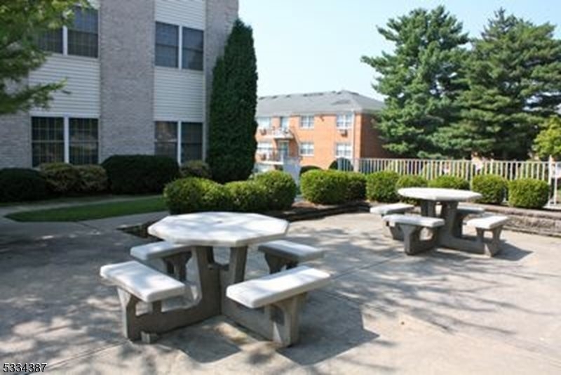 3203 Vail Road Parsippany, NJ 07054 - Photo 16 of 18 a view of a patio with table and chairs and potted plants