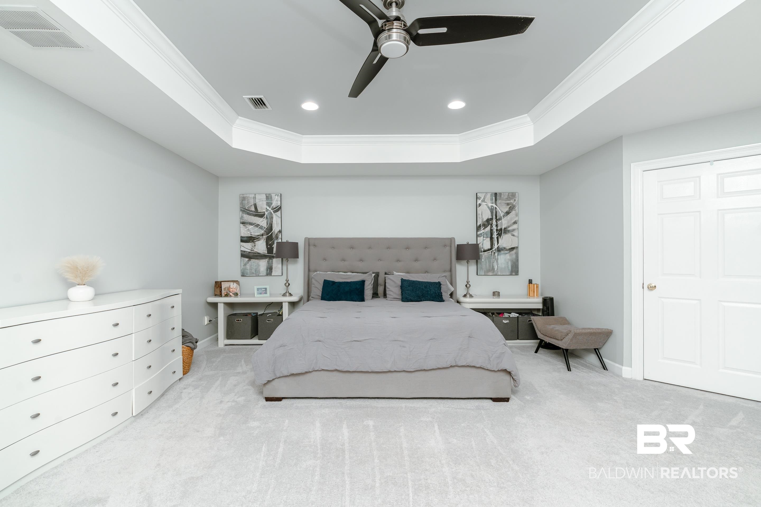 9477 Deerfield Drive Irvington, AL 36544 - Photo 18 of 58 Bedroom featuring ceiling fan, carpet flooring, and a tray ceiling