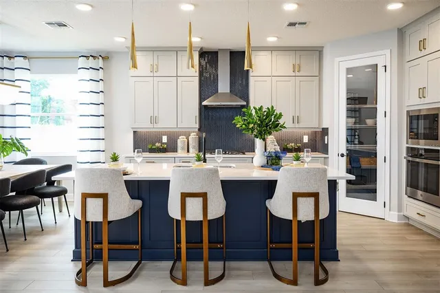 a kitchen with a table chairs refrigerator and microwave