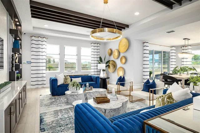 a living room with fireplace furniture and a large window