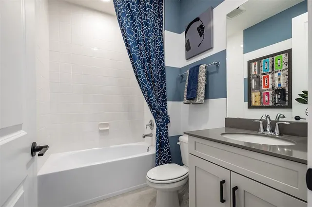 a bathroom with a granite countertop sink toilet and a bathtub