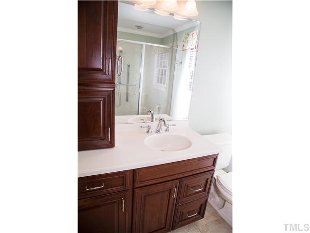 4809 Poland Place Raleigh, NC 27609 - Photo 18 of 25 a bathroom with a sink and a mirror