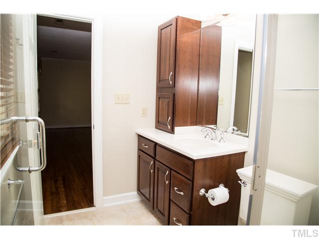 4809 Poland Place Raleigh, NC 27609 - Photo 23 of 25 a bathroom with a sink a vanity and a mirror