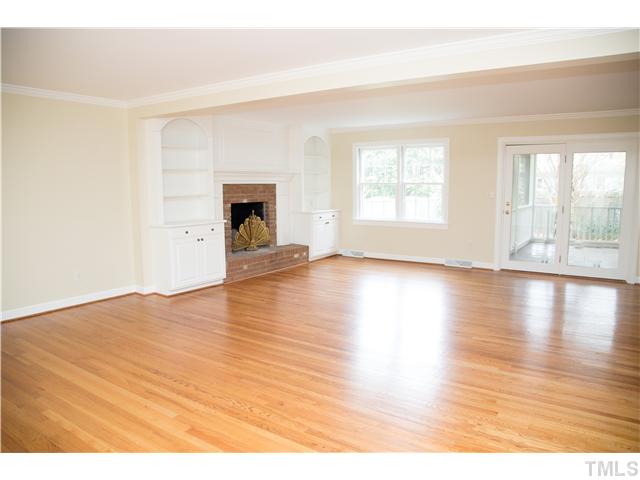 4809 Poland Place Raleigh, NC 27609 - Photo 4 of 25 a view of an empty room with window and wooden floor