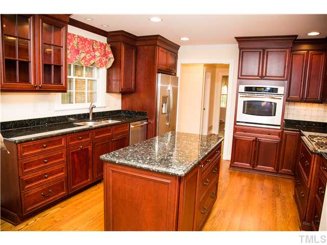 4809 Poland Place Raleigh, NC 27609 - Photo 8 of 25 a kitchen with stainless steel appliances granite countertop a sink stove and refrigerator