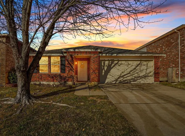 a view of a wooden house with a large tree