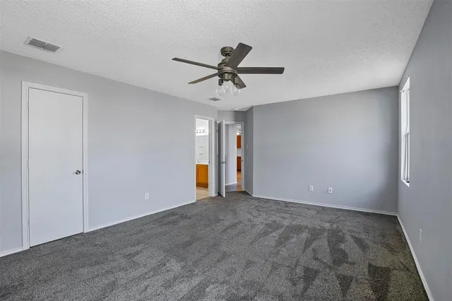 a view of a livingroom with a ceiling fan & chandelier fan