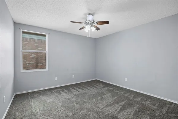a view of a big room with a chandelier fan