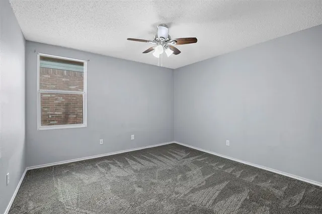 a view of a big room with a chandelier fan