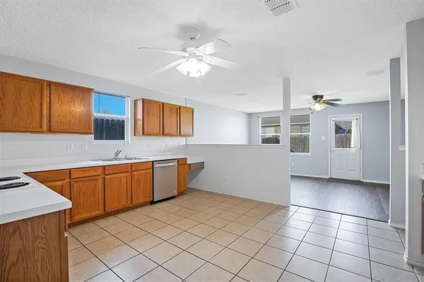 a kitchen with stainless steel appliances granite countertop a sink and cabinets