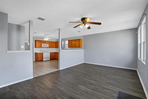 a view of a livingroom with a ceiling fan and wooden floor
