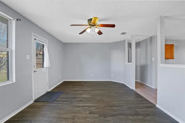 a view of empty room with wooden floor