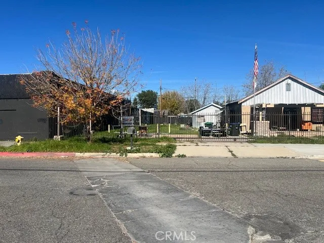 a view of a house with a big yard and large trees