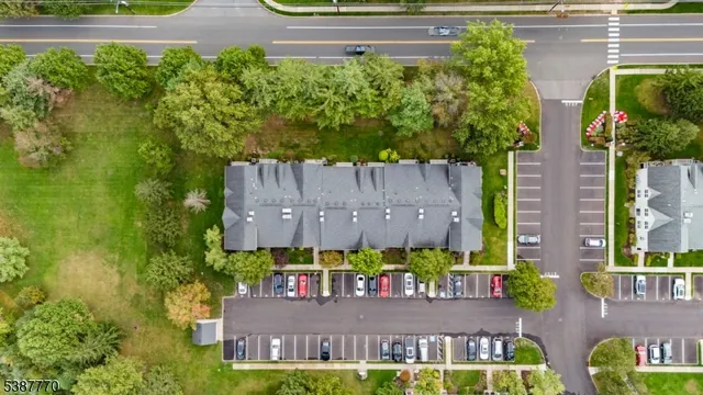 front view of a house with a small yard and potted plants