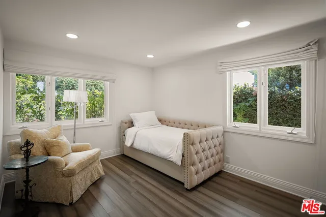 a spacious bedroom with a bed and a couch