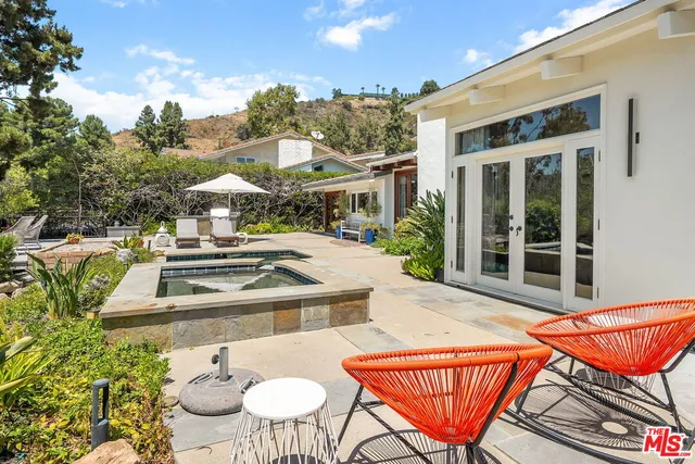 a view of a patio with table and chairs with wooden floor and fence