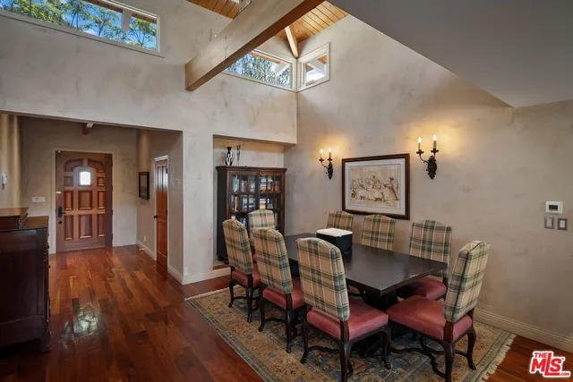 a dining room with furniture and wooden floor