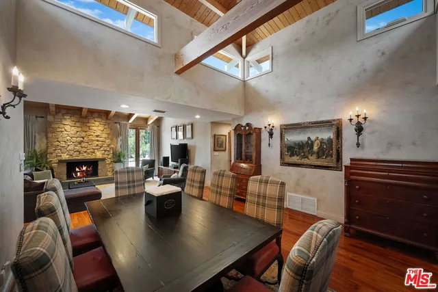 a living room with fireplace furniture and a flat screen tv