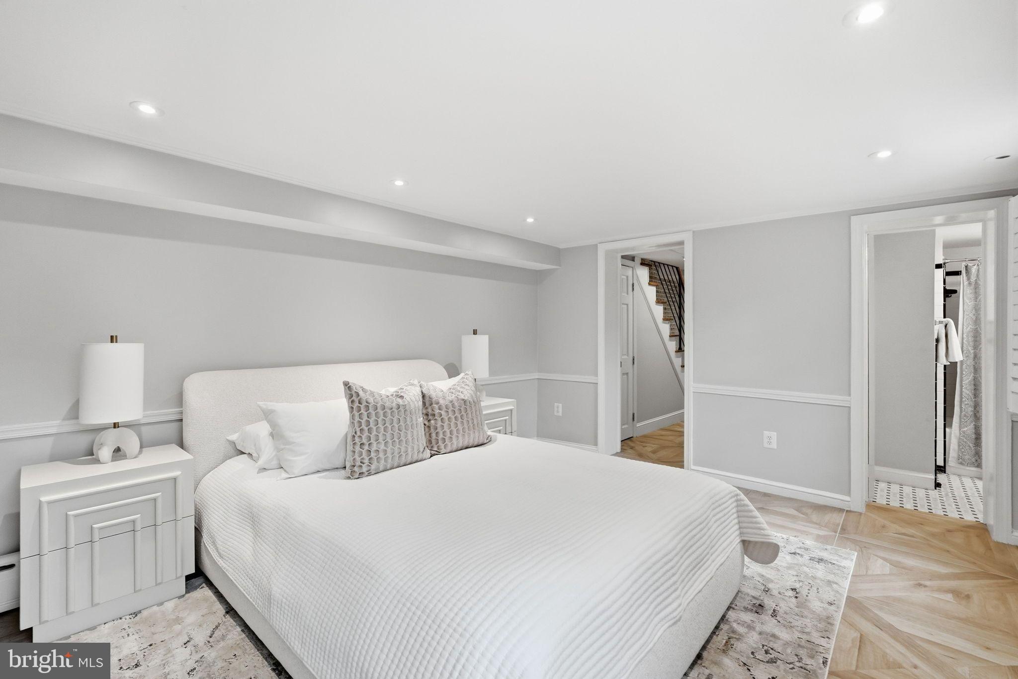 2708 P Street Northwest Washington, DC 20007 - Photo 27 of 35 a bedroom with a large bed and a chandelier