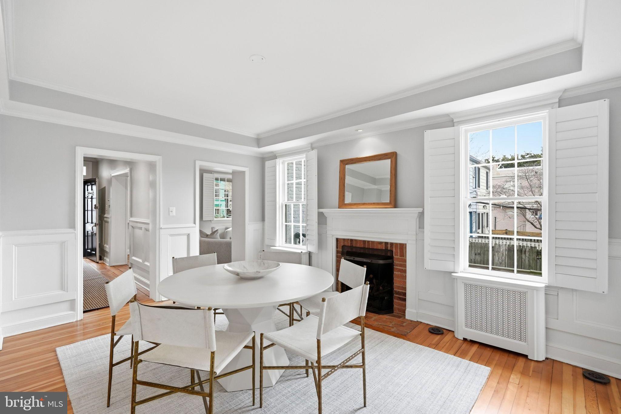 2708 P Street Northwest Washington, DC 20007 - Photo 5 of 35 a dining room with furniture a fireplace and wooden floor