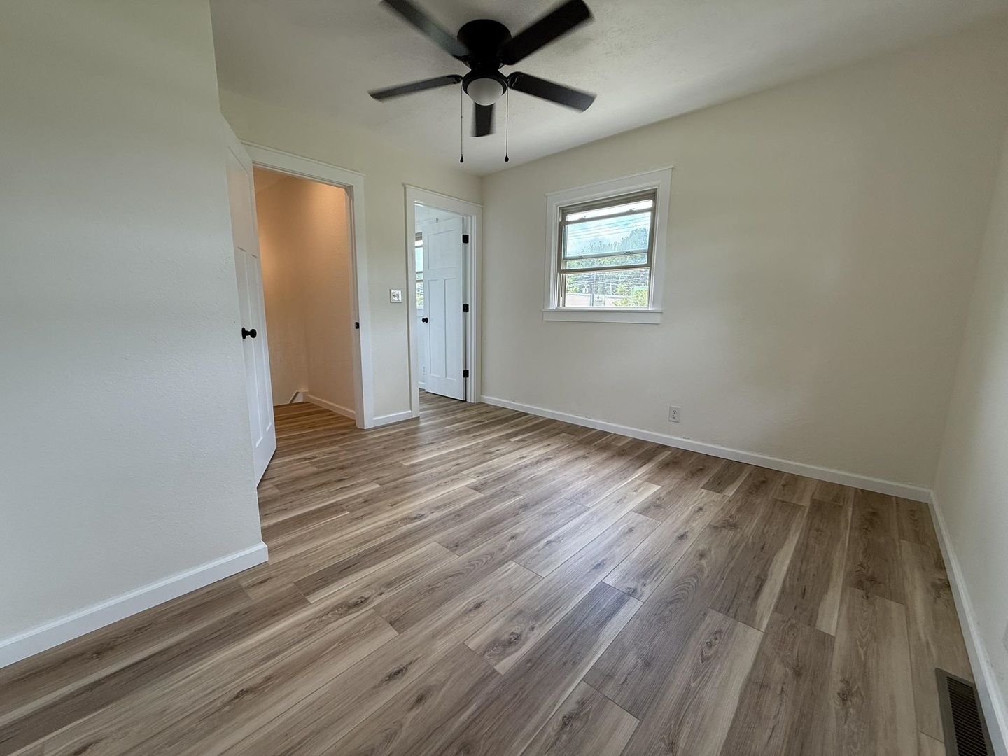 1103 West 10th Street Metropolis, IL 62960 - Photo 22 of 32 a view of an empty room with wooden floor and a window