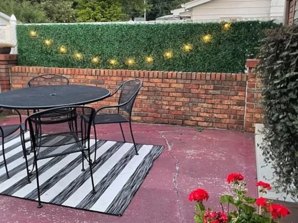 a view of a chairs and table in backyard
