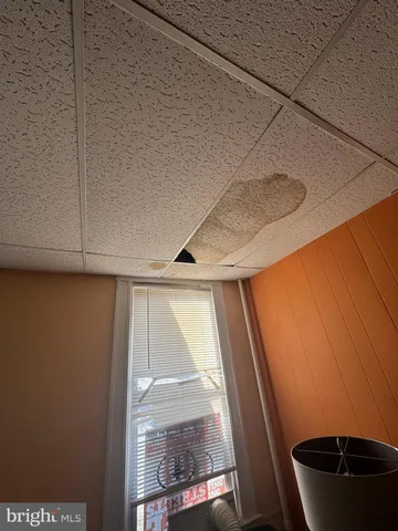 a living room with patio furniture and a flat screen tv