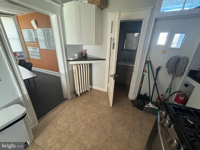 a room with water heater and wooden floor