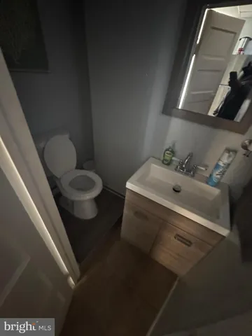 a view of a hallway with wooden floor and entryway