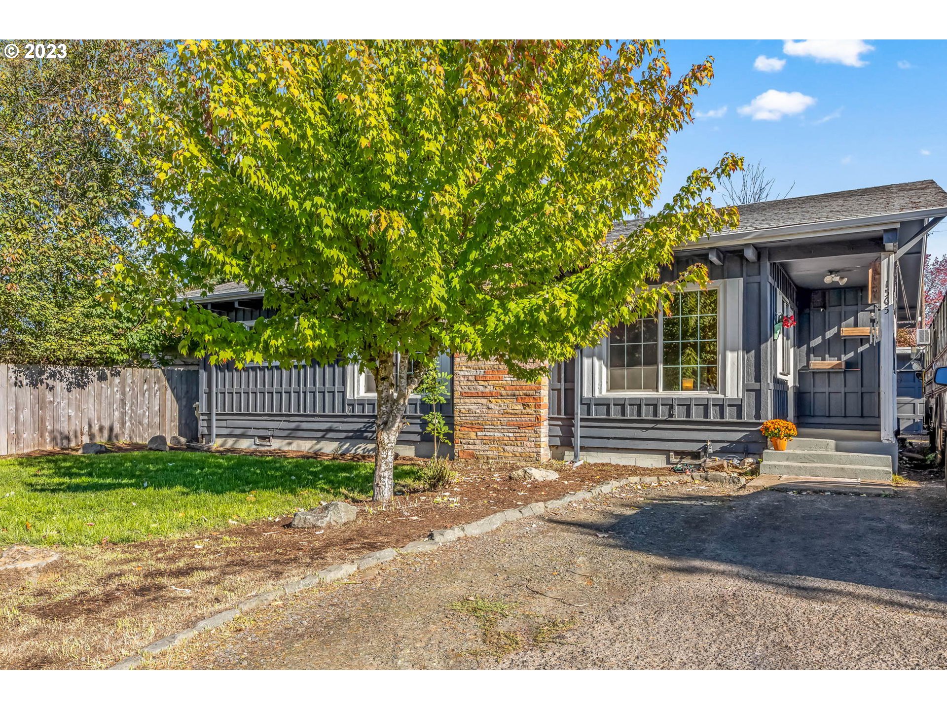 1565 Laura Street Springfield, OR 97477 - Photo 1 of 40 a backyard of a house with barbeque oven table and chairs