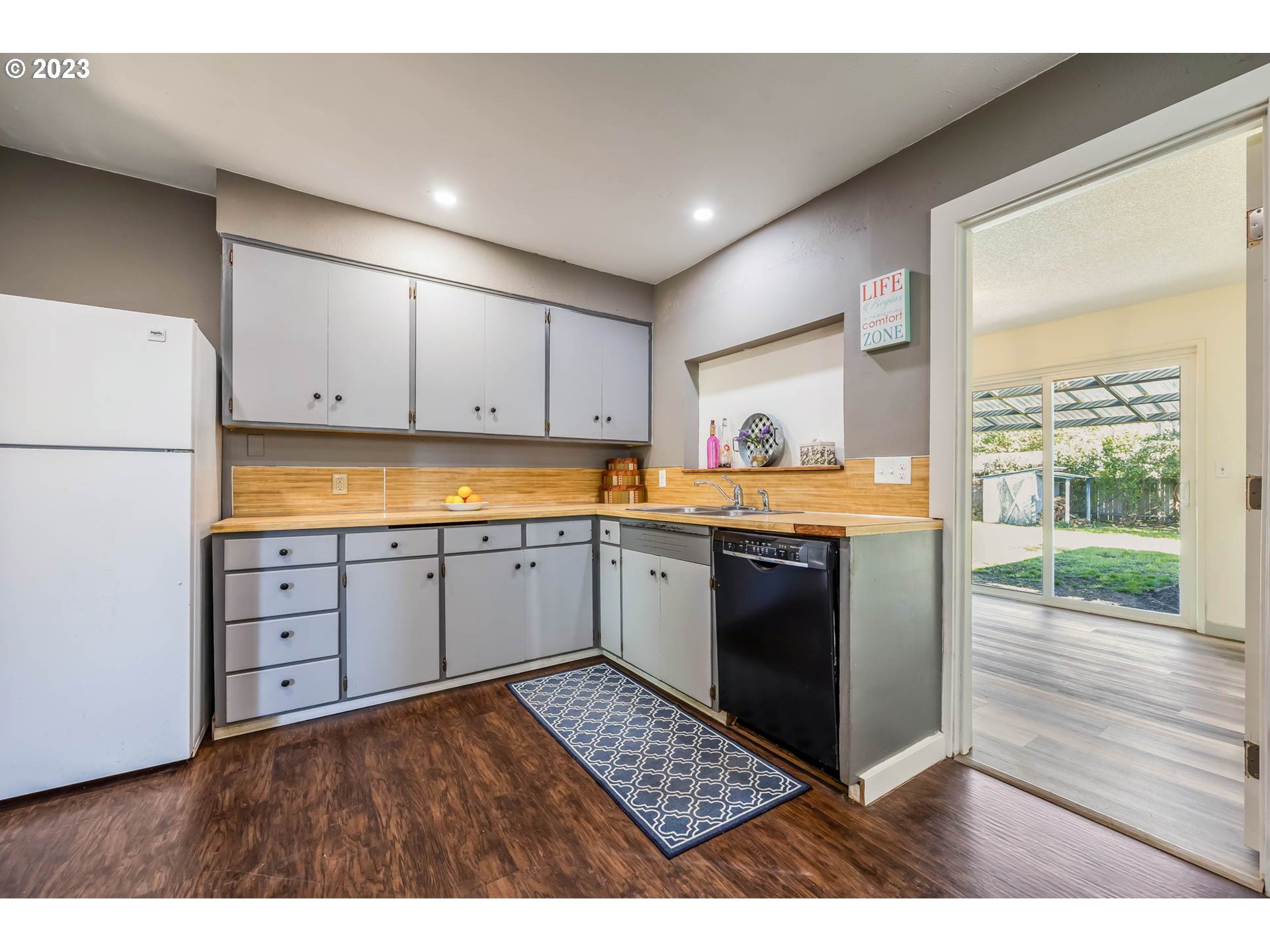 1565 Laura Street Springfield, OR 97477 - Photo 15 of 40 a kitchen with stainless steel appliances granite countertop a refrigerator sink and cabinets