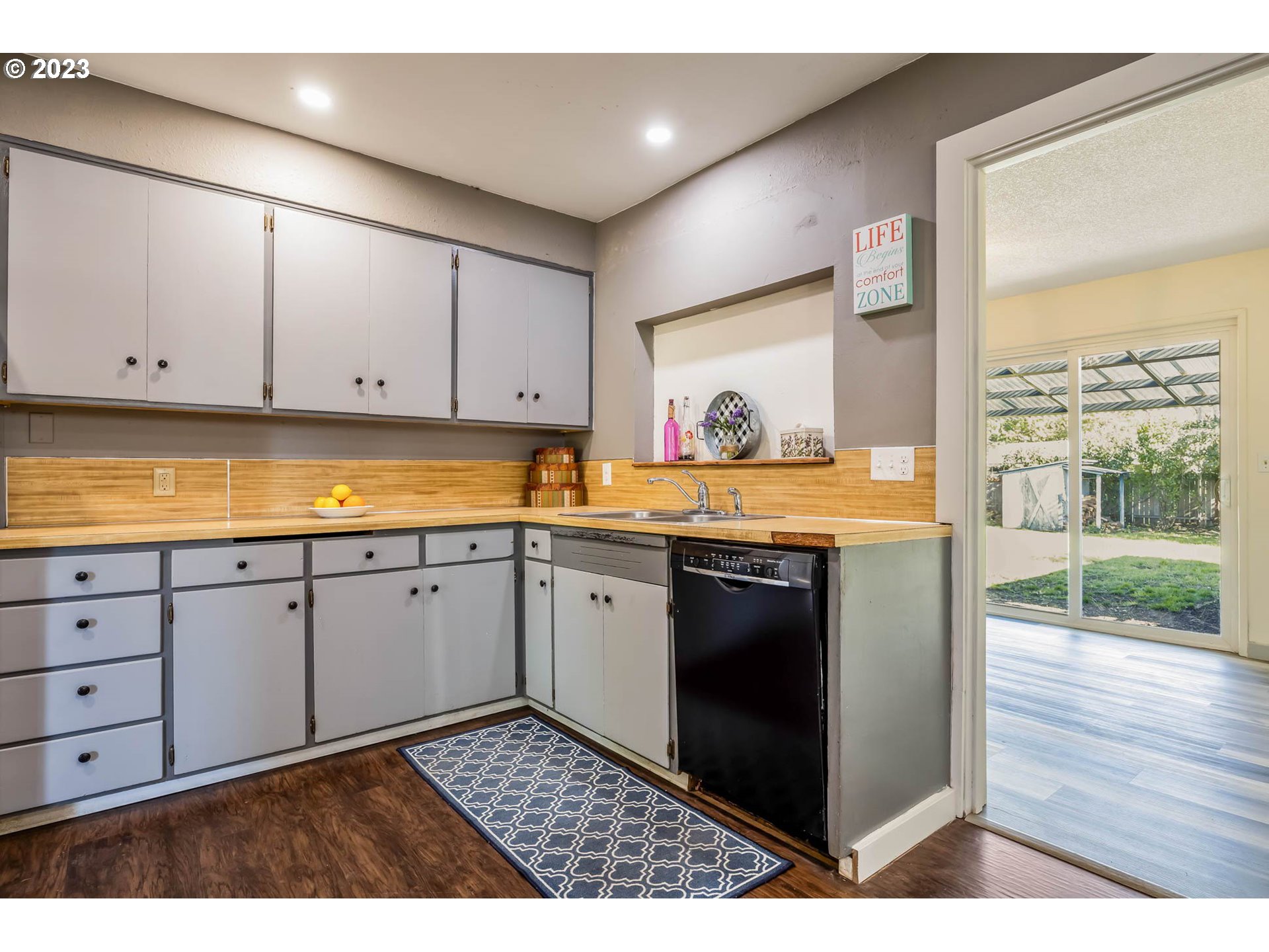 1565 Laura Street Springfield, OR 97477 - Photo 16 of 40 a kitchen with stainless steel appliances granite countertop a stove a sink and a microwave
