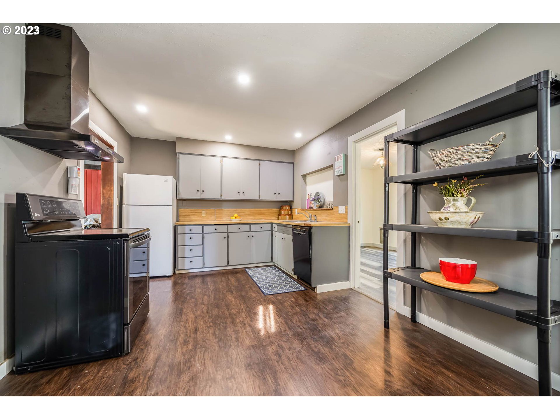 1565 Laura Street Springfield, OR 97477 - Photo 17 of 40 a open kitchen with stainless steel appliances granite countertop a refrigerator and microwave