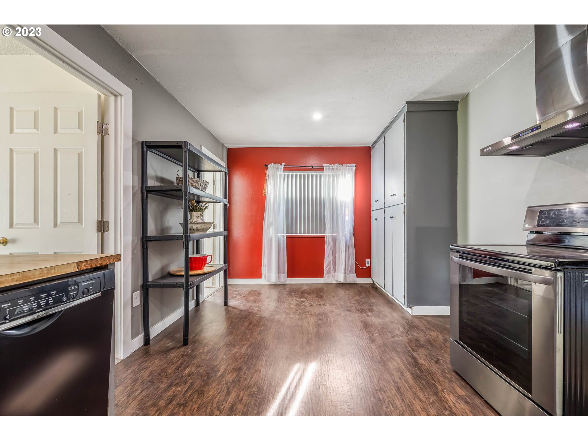 1565 Laura Street Springfield, OR 97477 - Photo 19 of 40 a open kitchen with stainless steel appliances granite countertop a stove and a wooden floors