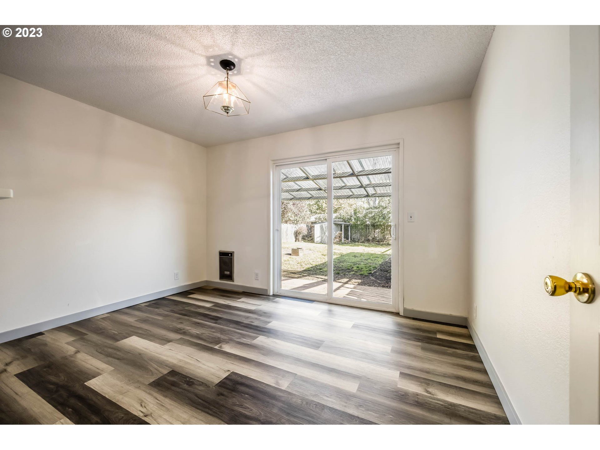 1565 Laura Street Springfield, OR 97477 - Photo 20 of 40 a view of an empty room with wooden floor and a window