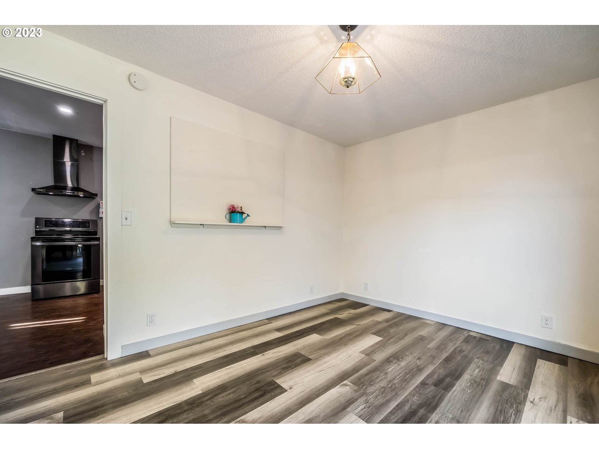 1565 Laura Street Springfield, OR 97477 - Photo 21 of 40 a view of empty room with wooden floor