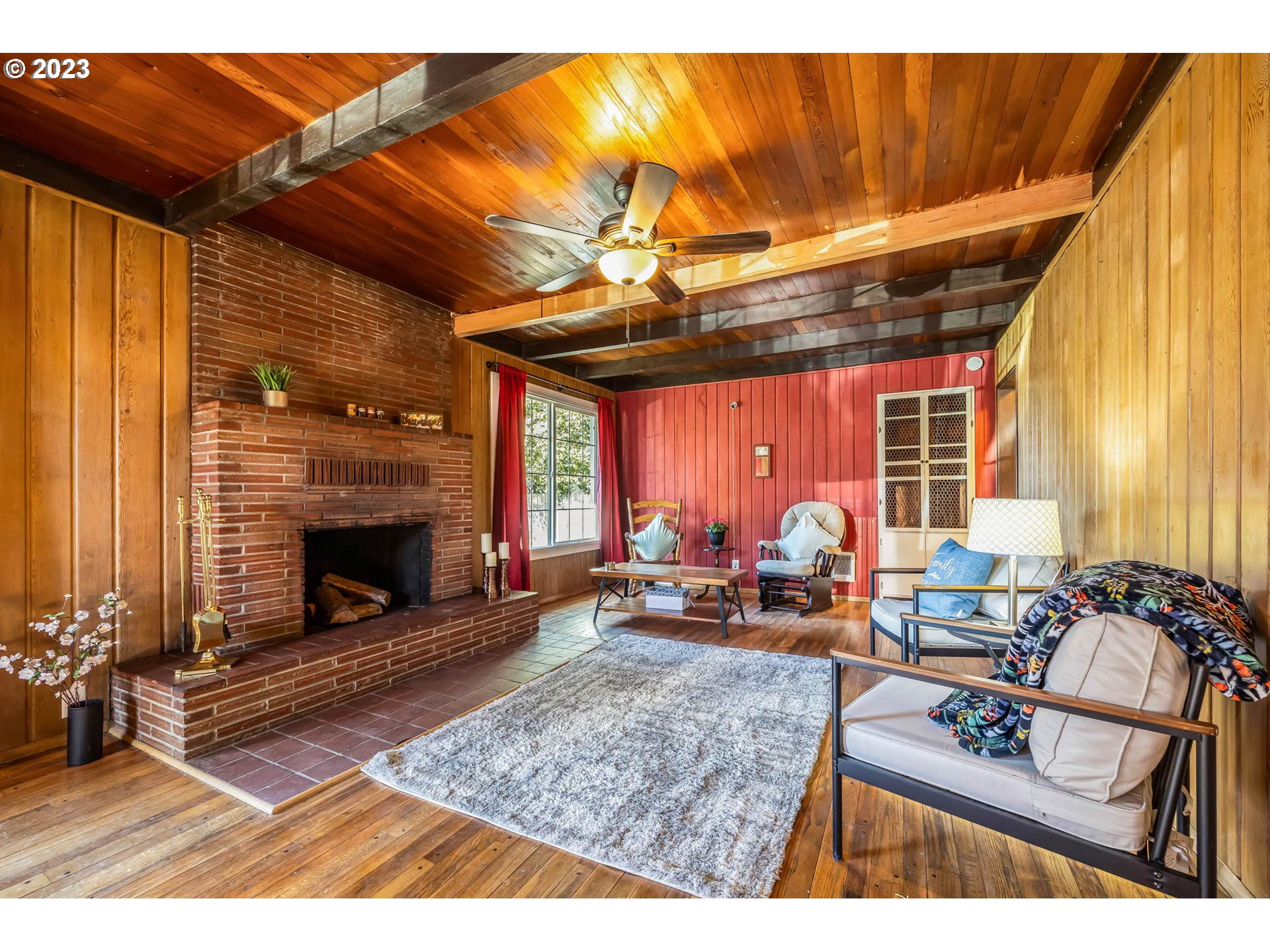 1565 Laura Street Springfield, OR 97477 - Photo 5 of 40 a living room with furniture a fireplace and a table