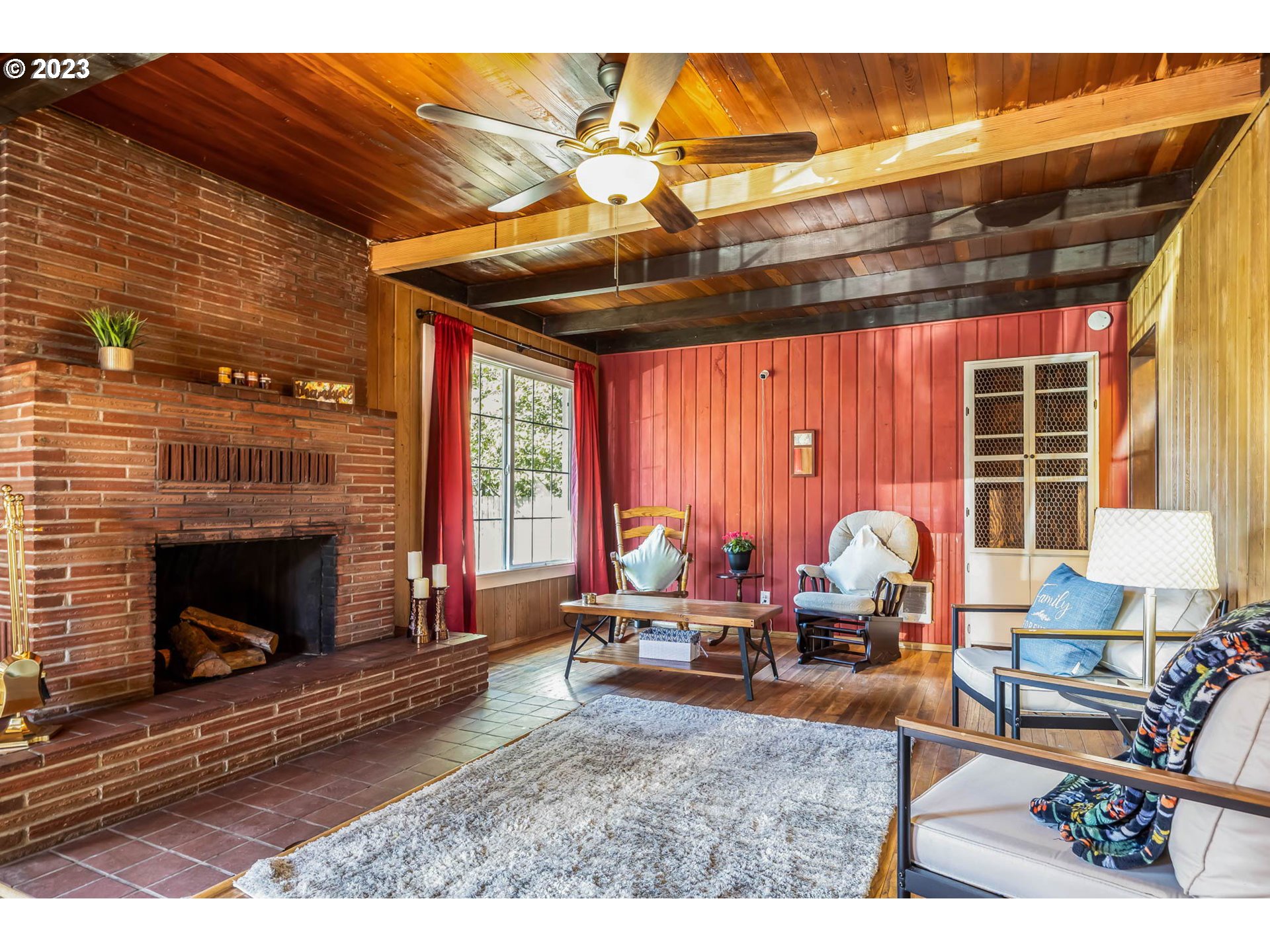 1565 Laura Street Springfield, OR 97477 - Photo 6 of 40 a living room with furniture a fireplace and wooden floor