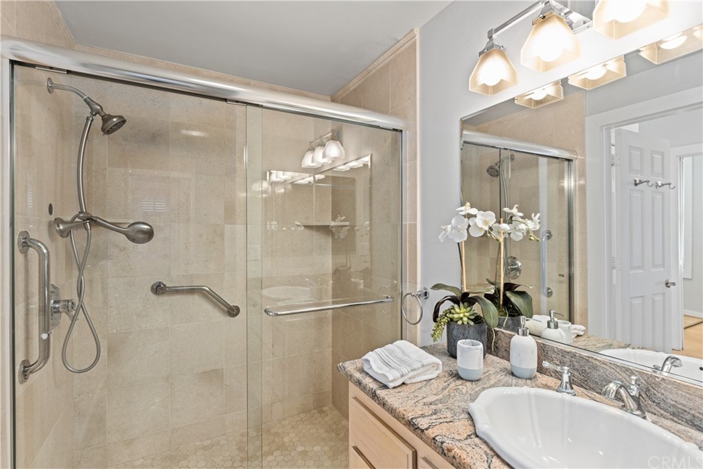 708 Cliff Drive Laguna Beach, CA 92651 - Photo 16 of 19 a bathroom with a granite countertop shower sink vanity and mirror