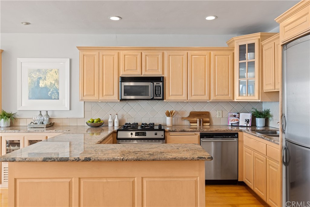 708 Cliff Drive Laguna Beach, CA 92651 - Photo 8 of 19 a kitchen with granite countertop white cabinets and white appliances